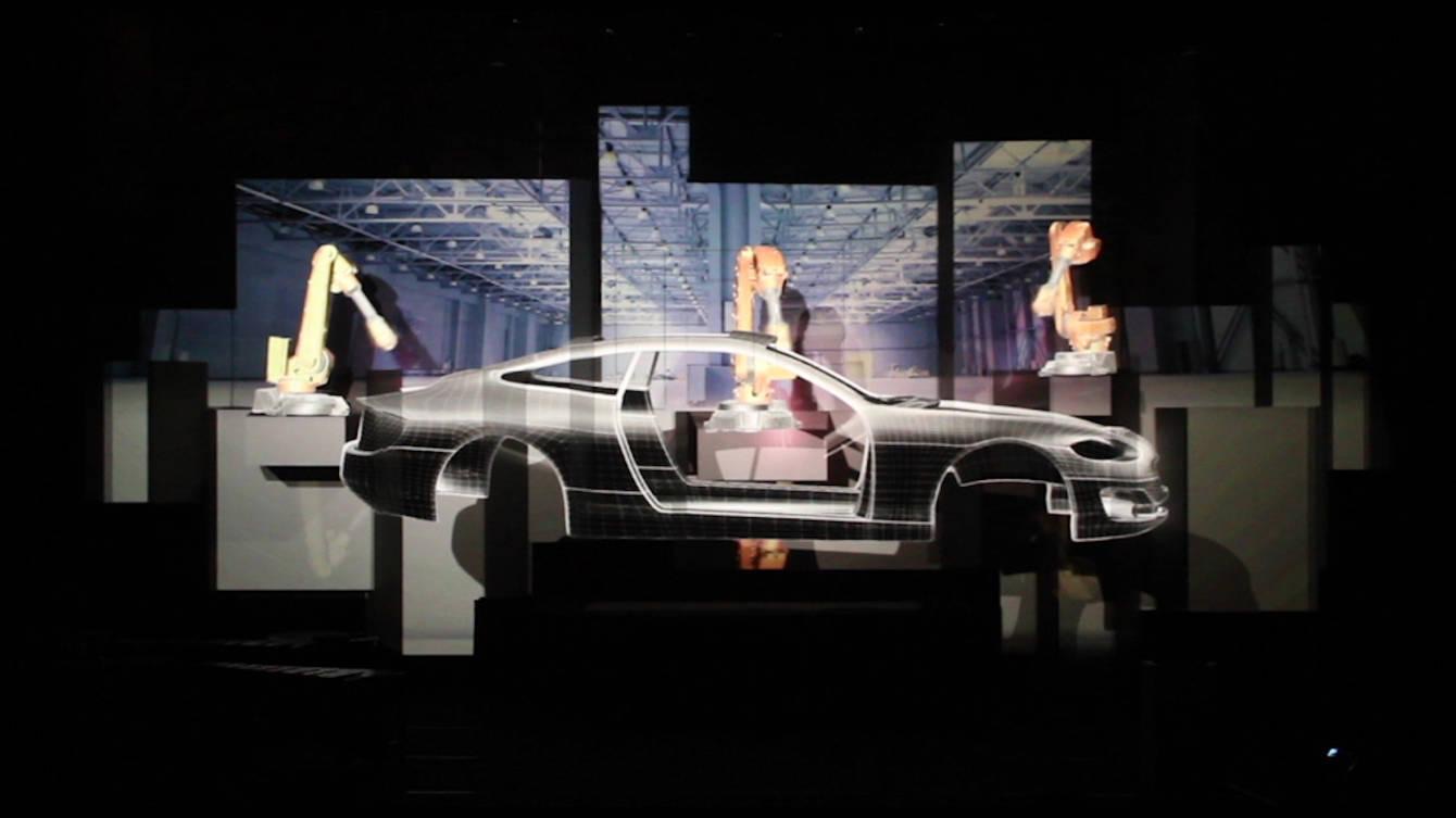 A stage of stacked projection-mapped cubes glowing blue during the Hannover Messe opening ceremony