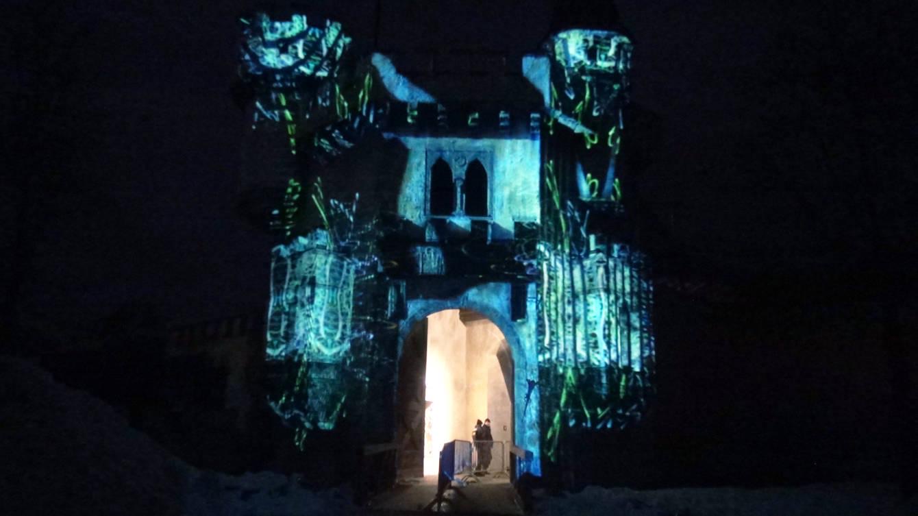 The façade of a castle in Austria illuminated by a projection mapping at night